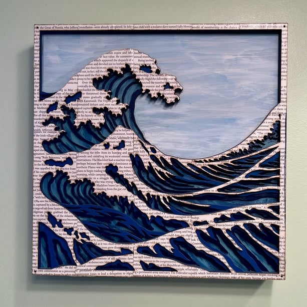 laser cut and painted three dimensional wooden ocean wave cresting with whitecaps made of book pages