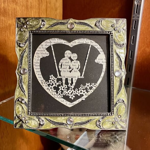 laser engraved layered paper silhouette of couple on a swing