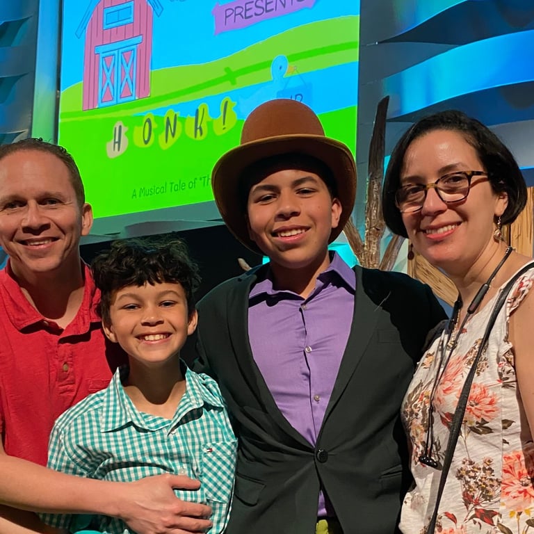 a family posing for a picture in front of a screen