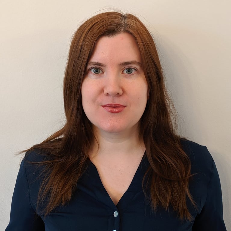 Adept Mediation professional female mediator smiling and looking directly at a client