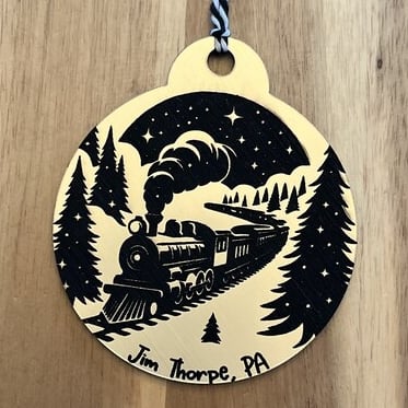 laser engraved acrylic ornament of steam train in winter