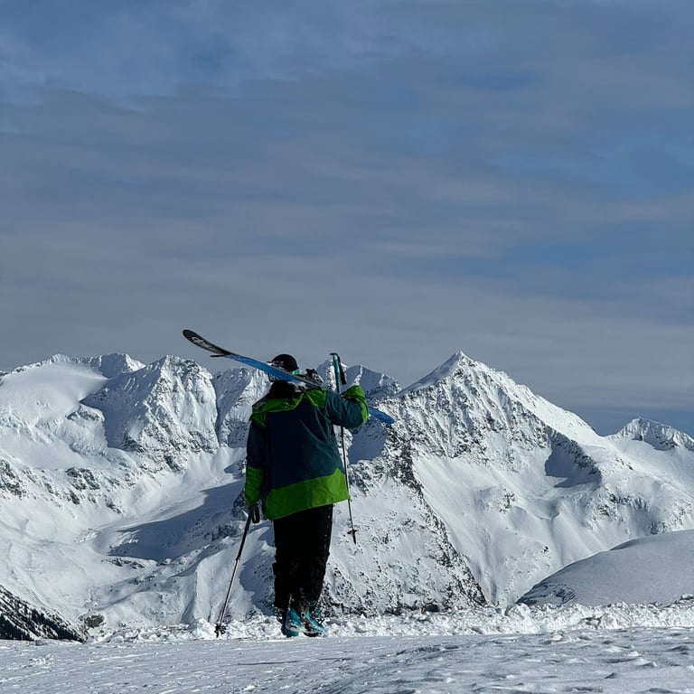 a person standing on a snowy mountain top