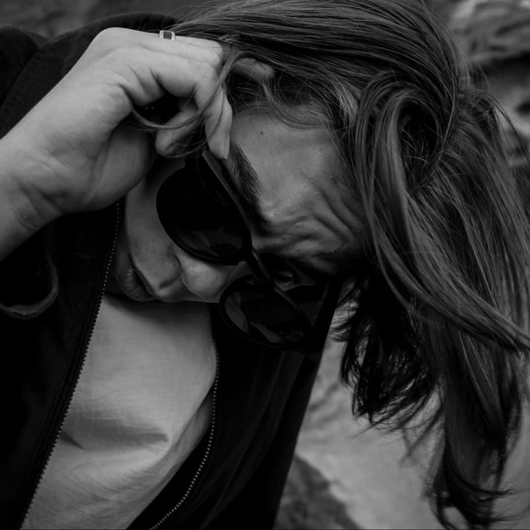 a man with a camera and sunglasses on