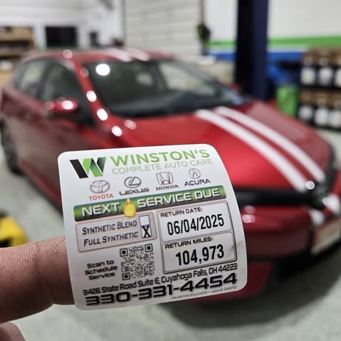 Car Service Sticker being placed on a car at Winston's Complete Auto Care in Cuyahoga Falls, Ohio
