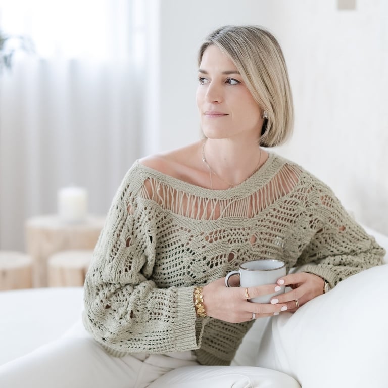 Yvonne, psychotherapist, having a coffee and looking calm, friendly and reflective