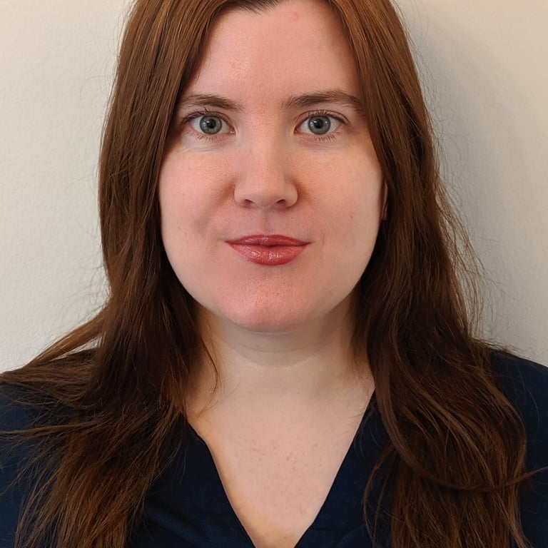 Adept Mediation professional female mediator smiling and looking directly at a client
