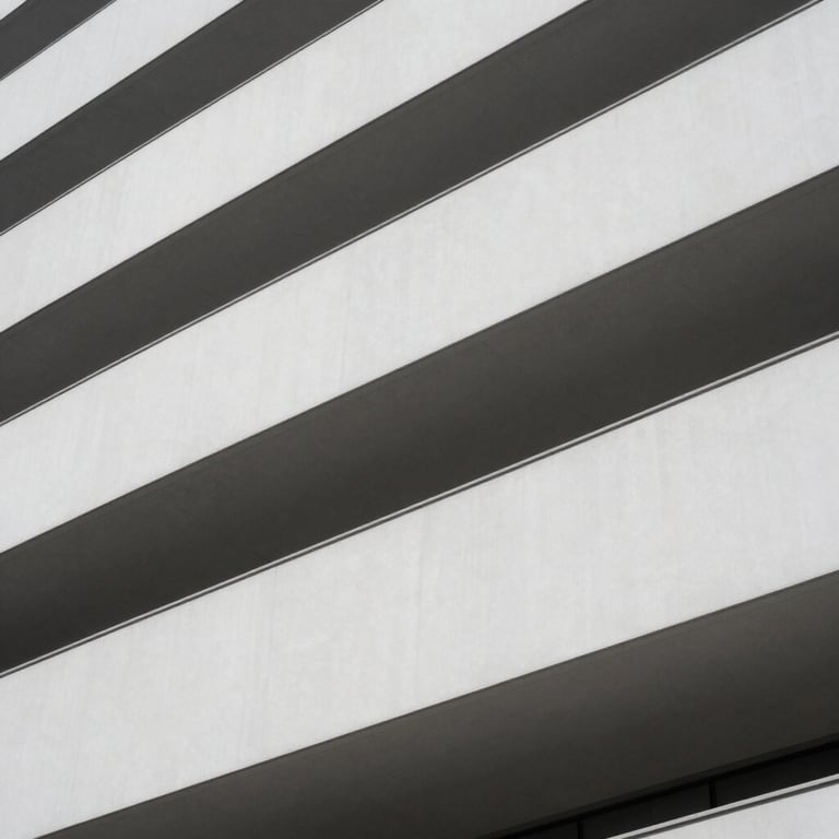 An abstract photography of modern architecture with clean lines and a soft white and grey color palette.