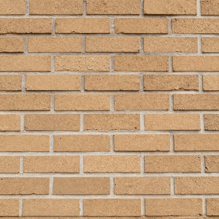 Architectural close-up of a perfectly aligned brick wall showing off-white mortar and medium tan textures.