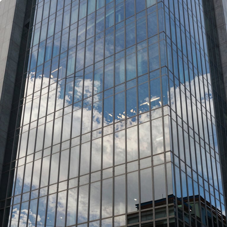 Reflective window film on a high-rise building reflecting the Indonesian sky.