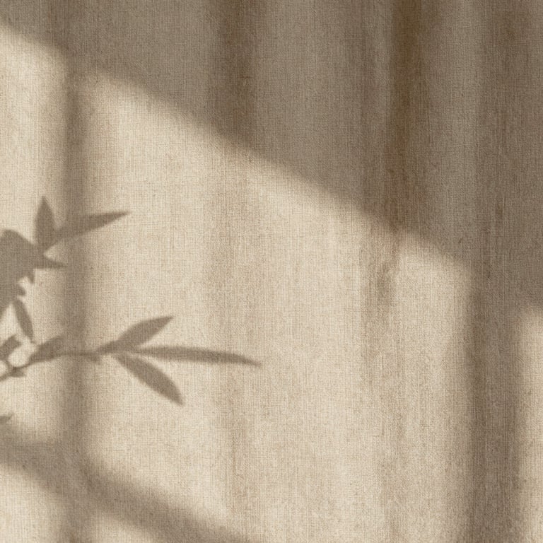 Close-up of natural textures, soft sunlight casting gentle shadows of leaves on a textured beige linen wall, peaceful and organic feel.
