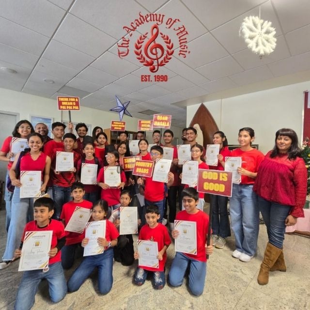 Academy of Music students and faculty with certificates at a community event