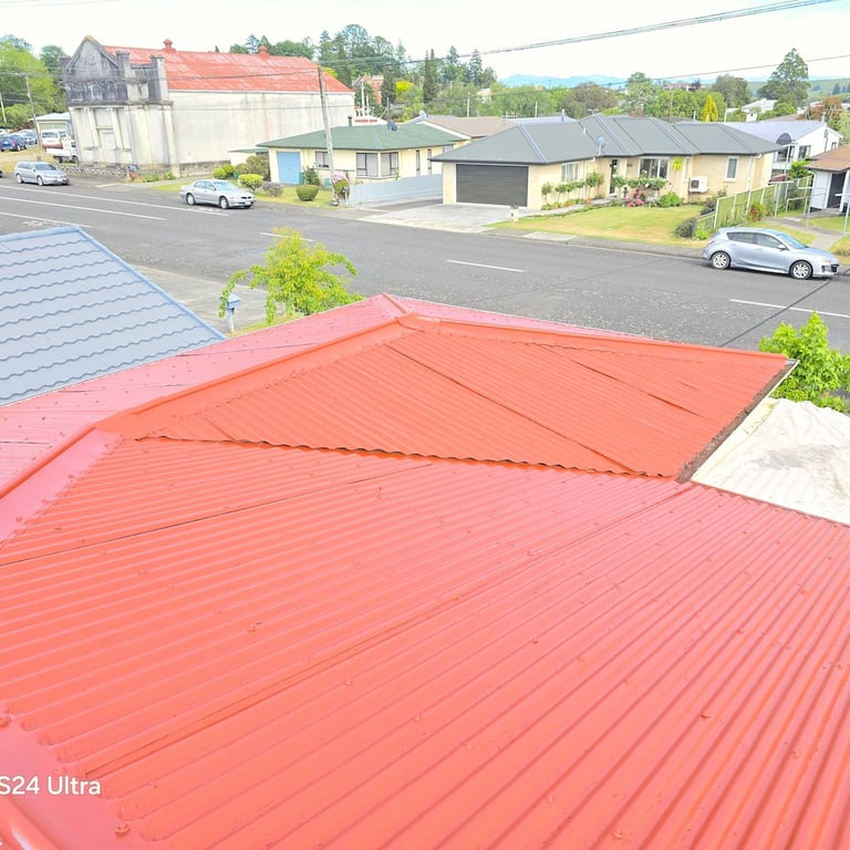 Freshly painted red corrugated roof with a smooth, even finish,