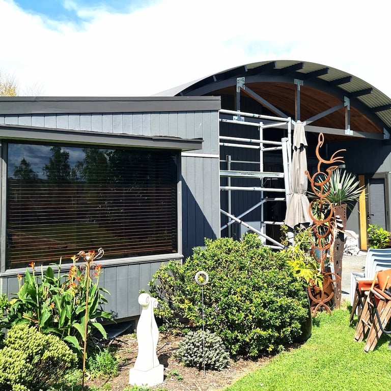 Modern home with freshly painted blue-grey exterior painted by Glen and his team