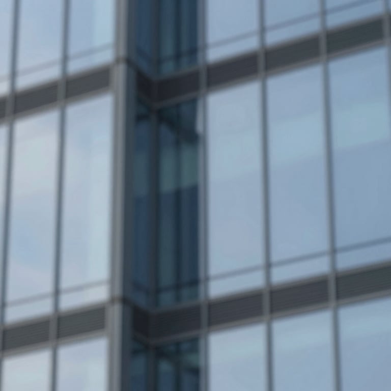An abstract architectural shot of a modern glass building reflecting a clear sky, representing transparency and professional growth.