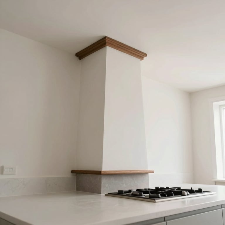 A low-angle shot of a newly installed designer chimney in a bright, modern kitchen with off-white countertops.