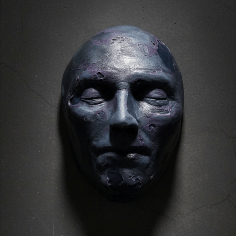 Spirit Shell #2  Wall hanging Sculpture (Gallery View) Paper Mache and Acrylic Paint. Blue and purple tones on face sculpture