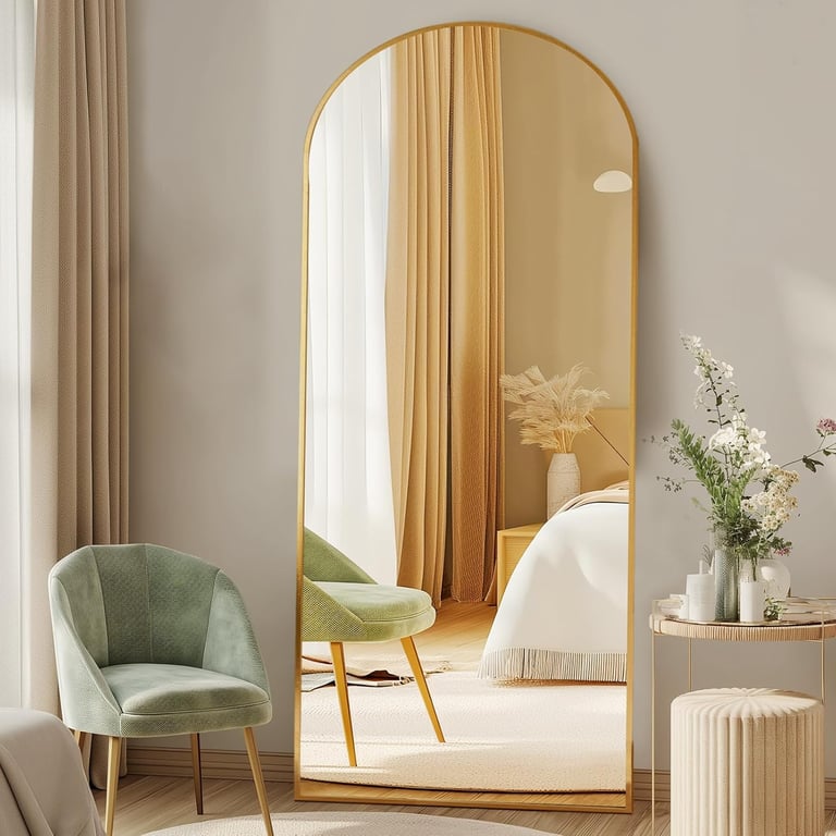 DUMOS arched floor mirror with gold frame styled in a modern bedroom interior