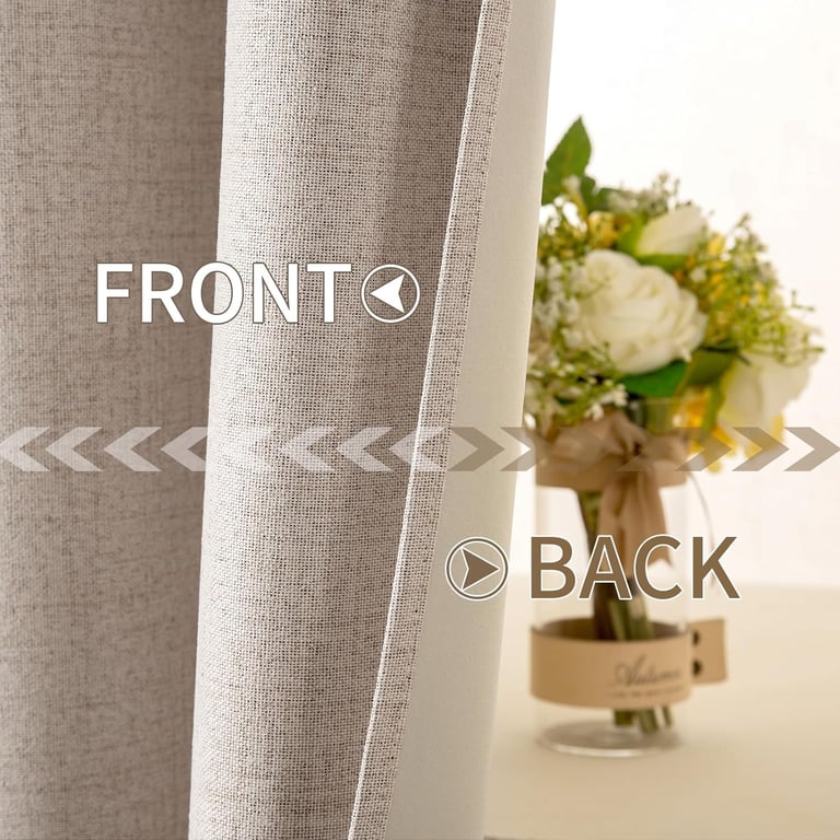 Close-up of linen textured blackout curtain fabric showing front and back layers beside a flower vase.