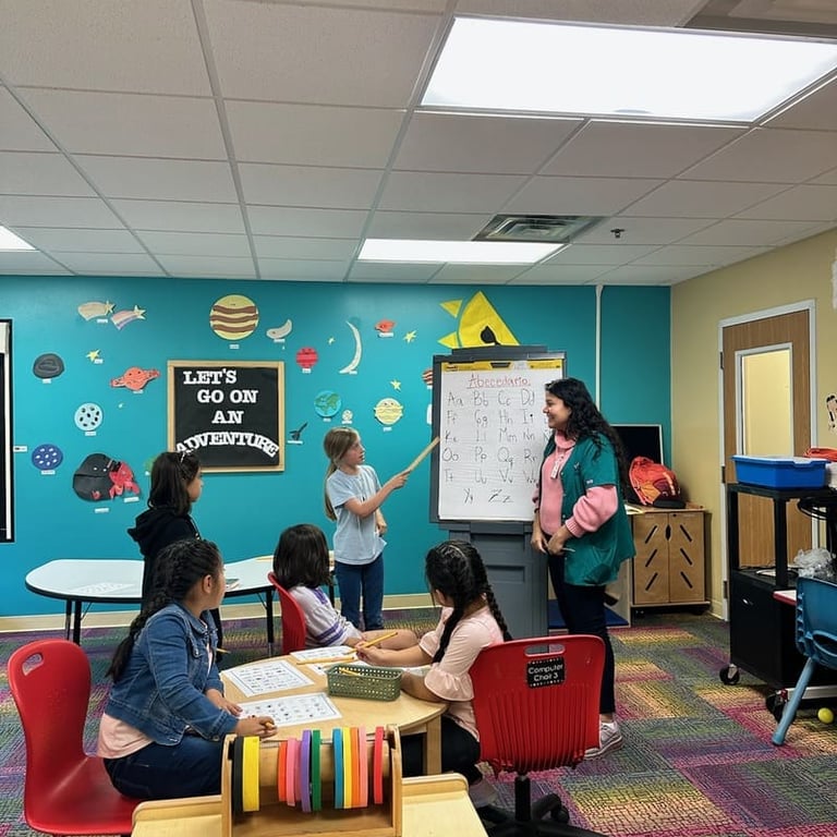 A primary student leads an alphabet lesson for a group of children in a colorful elementary classroom.
