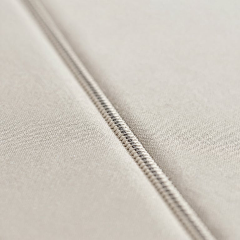 Close-up of a high-precision stitching pattern on a luxury garment, emphasizing the quality of the thread.