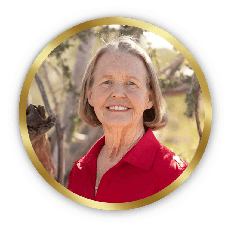 Smiling senior woman in a red shirt framed in a gold circle portrait.