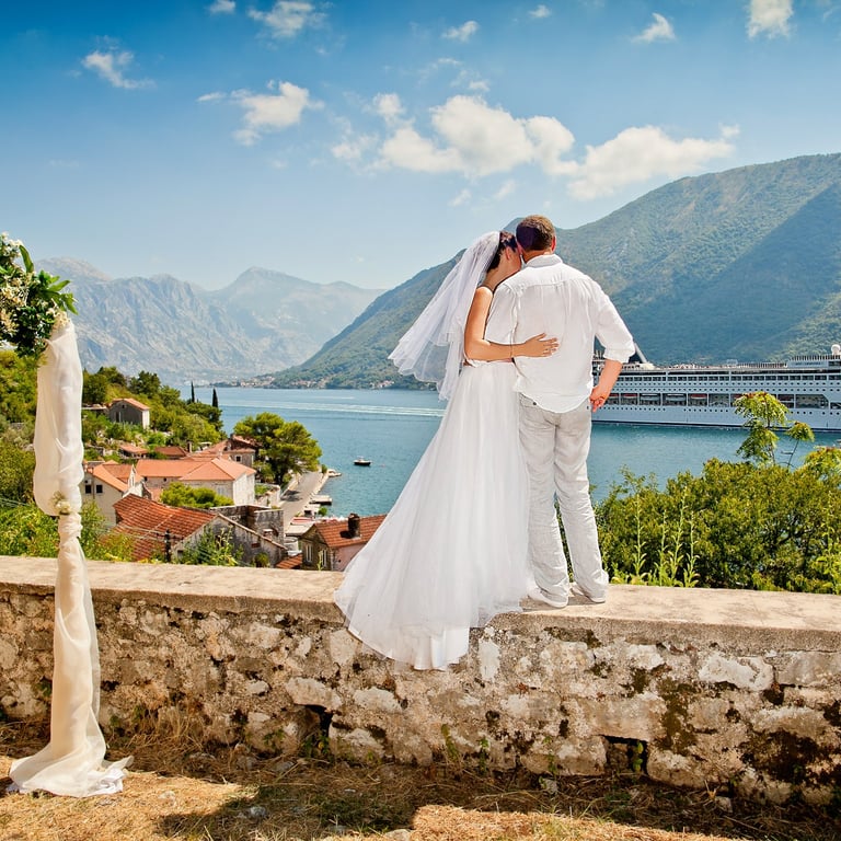 Wedding couple photo of Boka bay ceremony with wedding arch and cruise liner ship