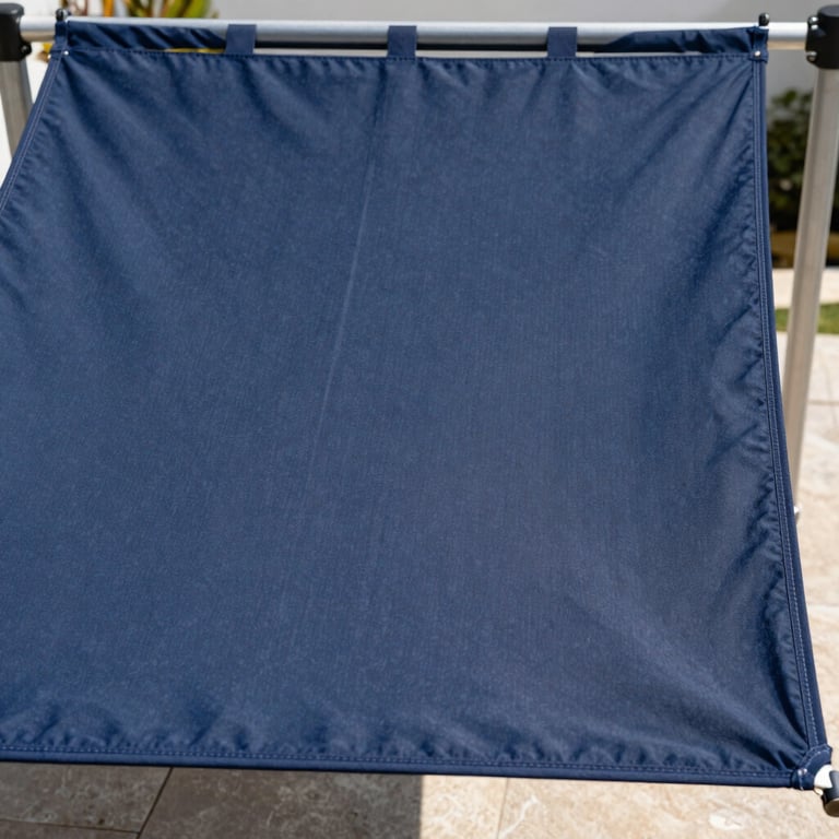 Before and after comparison of a luxury sunshade fabric restoration from faded to deep navy blue, bright outdoor setting.