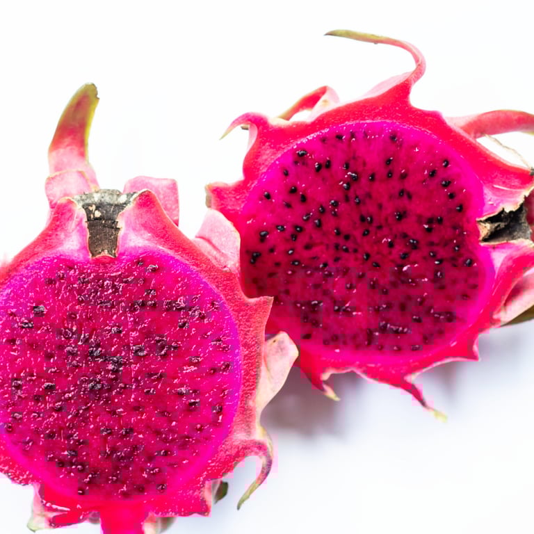 Fresh dragon fruit cut in half showing vibrant pink pulp and black seeds