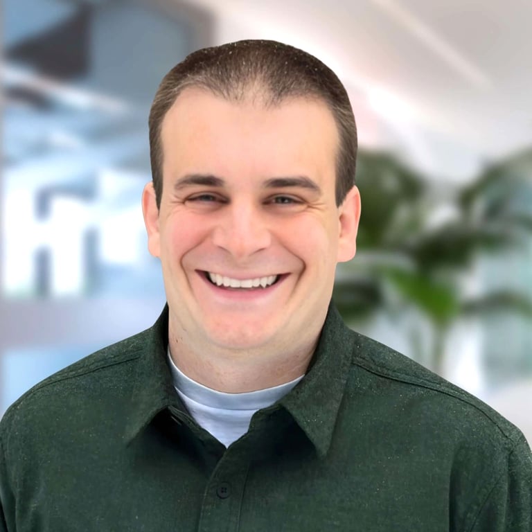 a man in a green shirt smiling at the camera