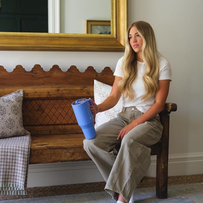 HydroJug Traveler 40oz water bottle in light blue, featuring a flip straw lid, grip handle