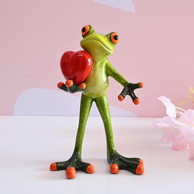 A resin frog figurine holding a heart, adding a playful and charming touch to any space. 