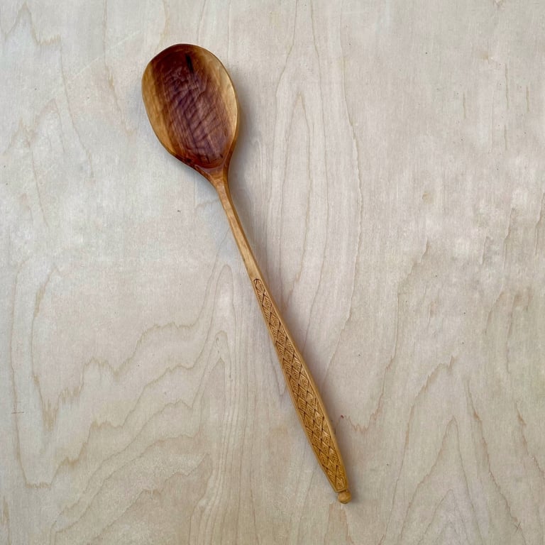 Apple cooking spoon with hand-carved feather details