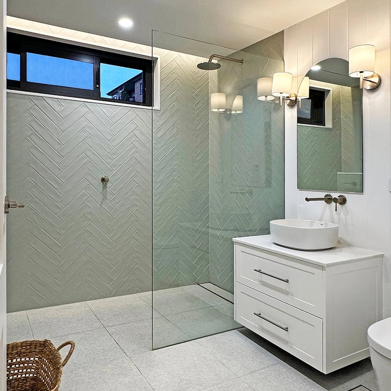 Luxury ensuite bathroom with minimalist design, featuring brushed nickel finishes, custom cabinetry, and subway tiles