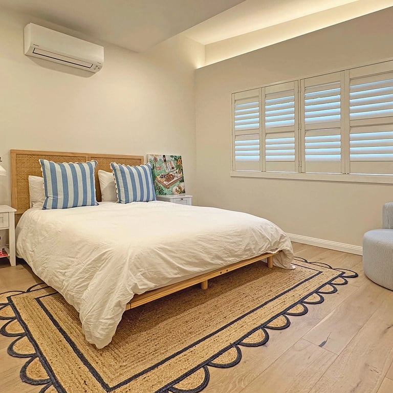 Minimalist bedroom sanctuary with custom joinery and a neutral palette in a Maroubra home.