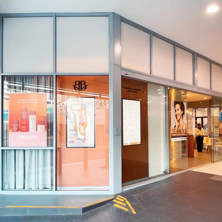 Bronze-clad exterior facade with digital screens for salon branding