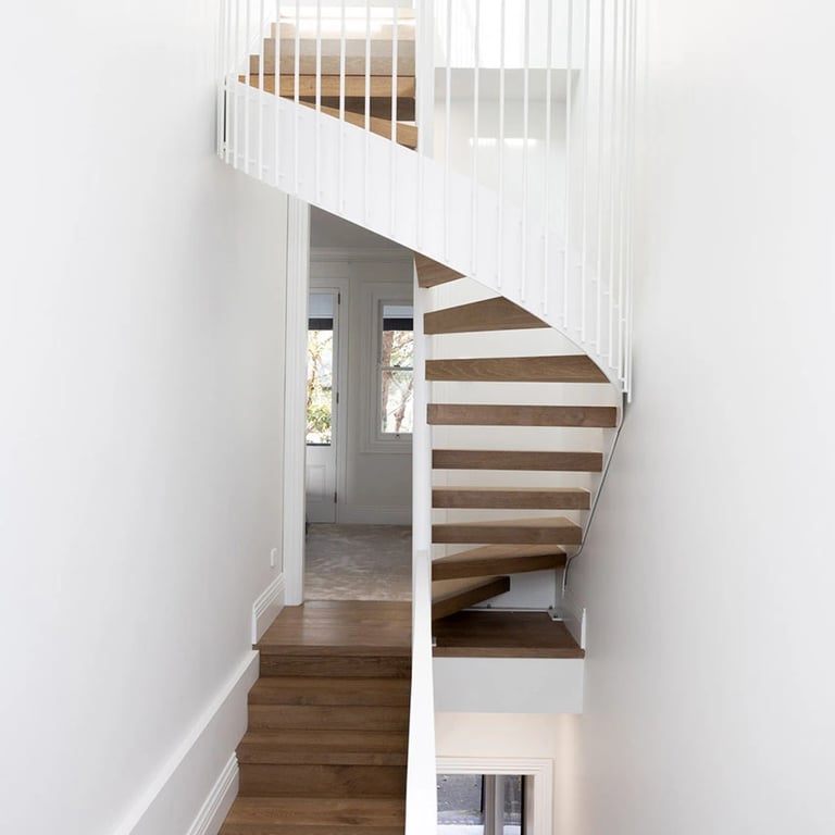 New metal spiral staircase to attic floor in Victorian terrace, blending heritage charm with modern design