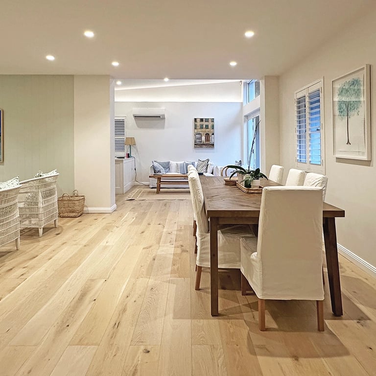 Open-concept living and dining area with fluid spatial composition and abundant natural light.