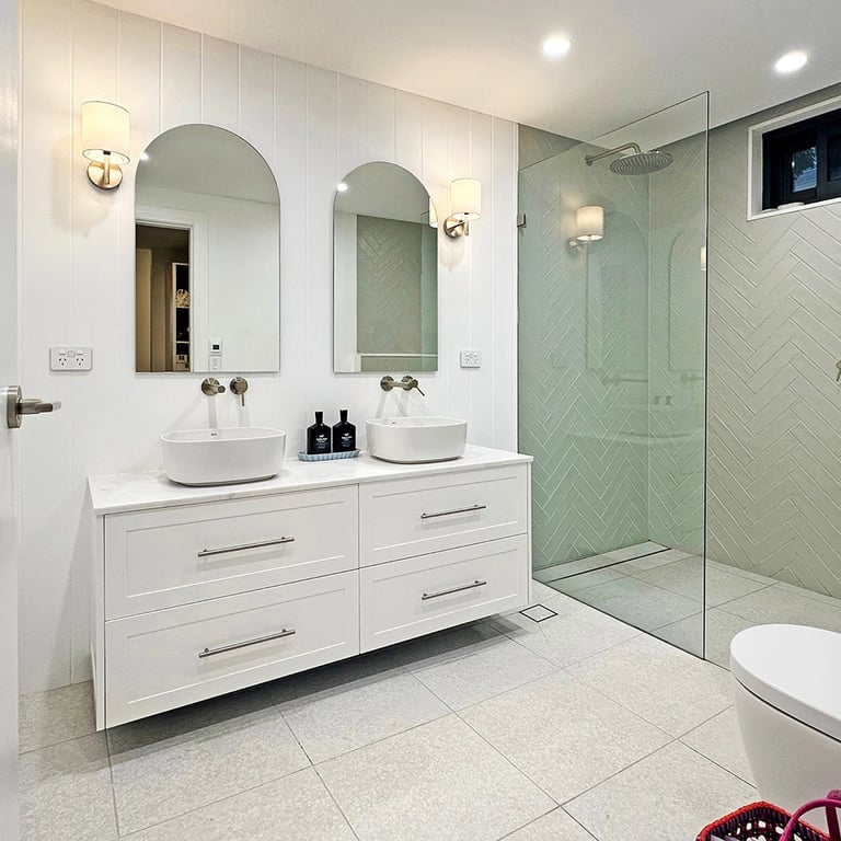 Spa-inspired family bathroom with frameless glass shower and organic material palette for a serene retreat