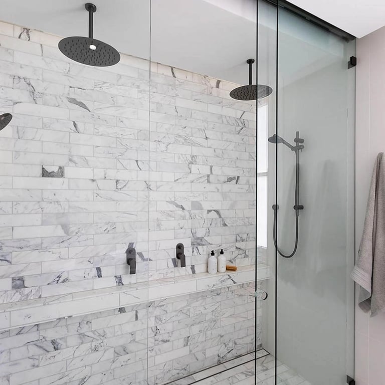 Spa-like bathroom with rainhead shower, heated stone flooring, and adaptive lighting for daily rhythms.