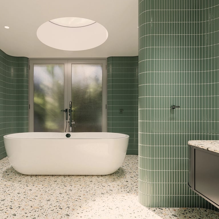 Frestanding oval tub in a tiled-wall room, terrazzo flooring and large round skylight