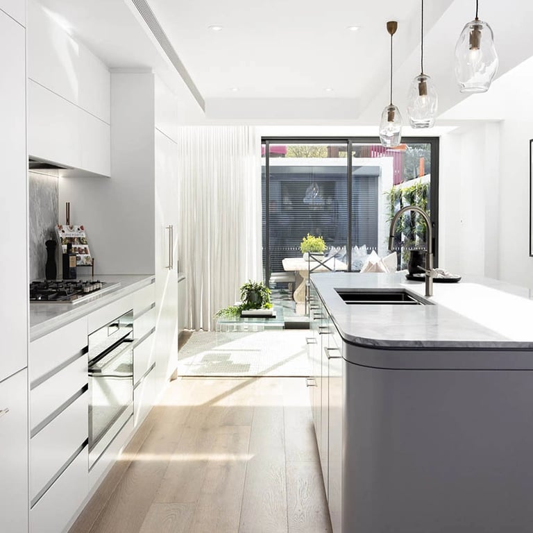 Modernist culinary space with custom-made joinery, climate-controlled wine storage, and natural light amplification