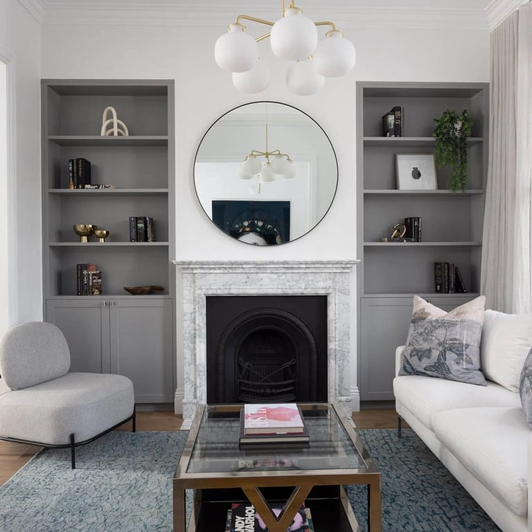 Relaxing lounge area with a restored Victorian fireplace, custom millwork, and tactile modernist finishes