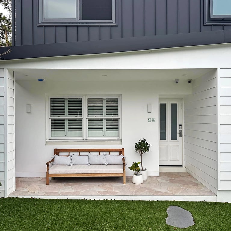 Architect-designed family home featuring a bold Hampton Brutalist exterior with matte black and white contrast.