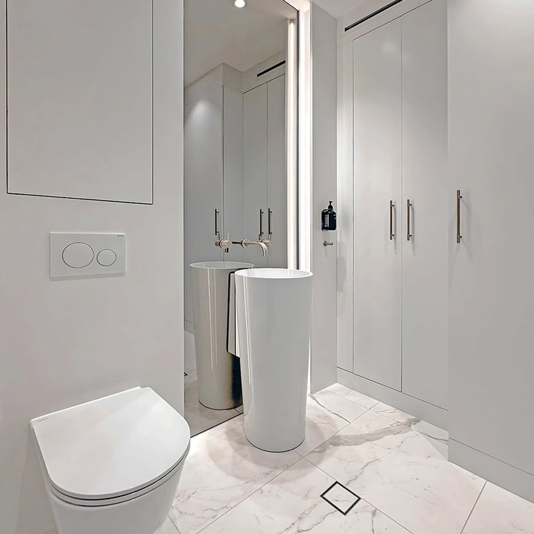 elegant powder room makeover in Mosman with Calacatta marble, floating vanity and hidden laundry storage