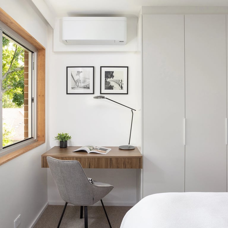 Interior design of the cozy bedroom in Mosman with white joinery cabinetry and a study desk