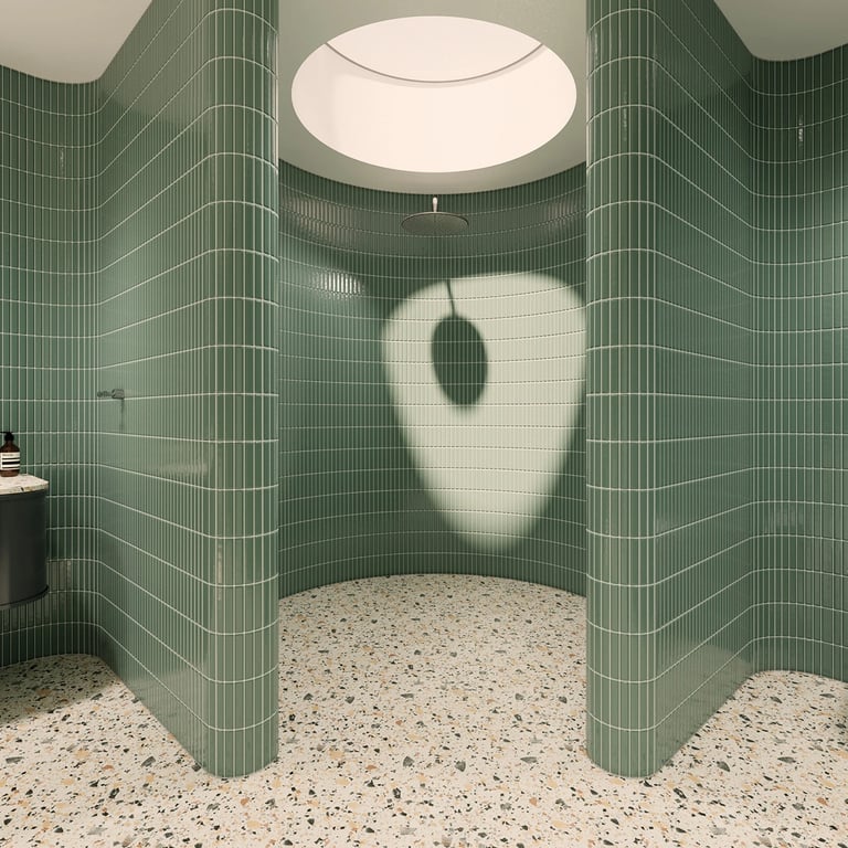 Circular rain shower under a skylight, lined with fluted tiles and a decorative bronze drain