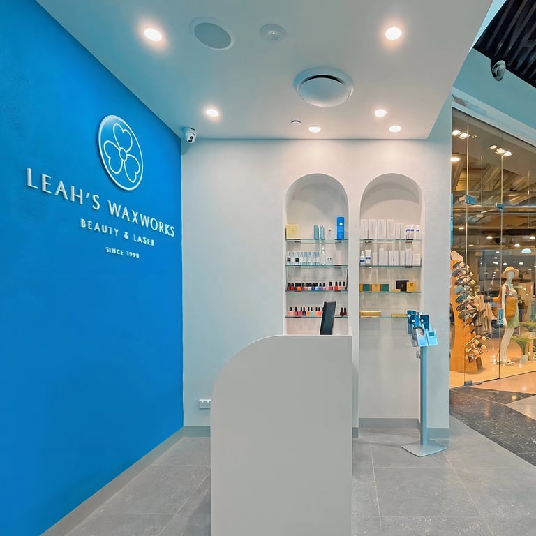 Curved reception desk with polished terrazzo base, arched niches for product display, feature wall with main logo