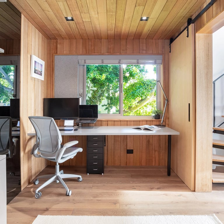 cozy study room and office finished in victorian ash timber paneling with a view to green aspects of Mosman
