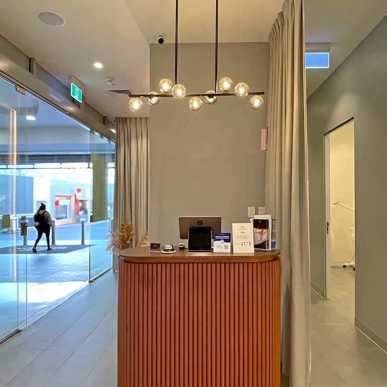 Bronze-themed beauty salon reception desk with modern chandelier