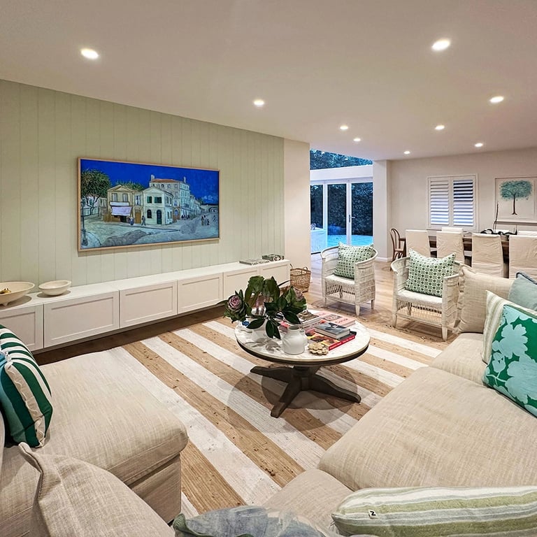 Open-plan living area with custom oak flooring, bespoke joinery, and seamless indoor-outdoor flow.